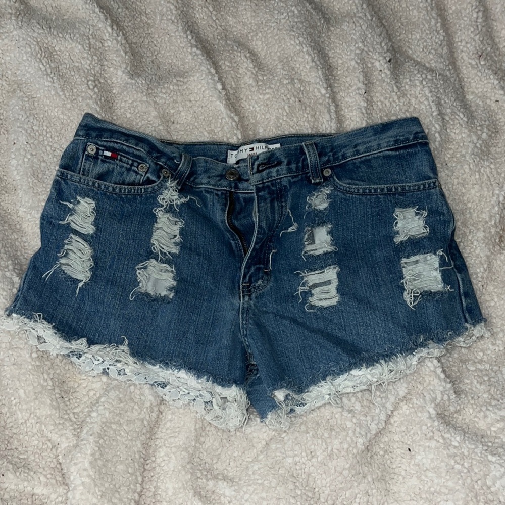 Size 8 distressed jean shorts w/ lace on bottom fringes. Good condition.